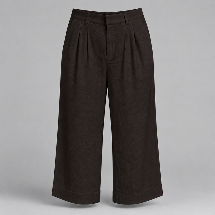 Dark brown cropped wide-leg trousers with pleated front details, shown on a neutral gray background.